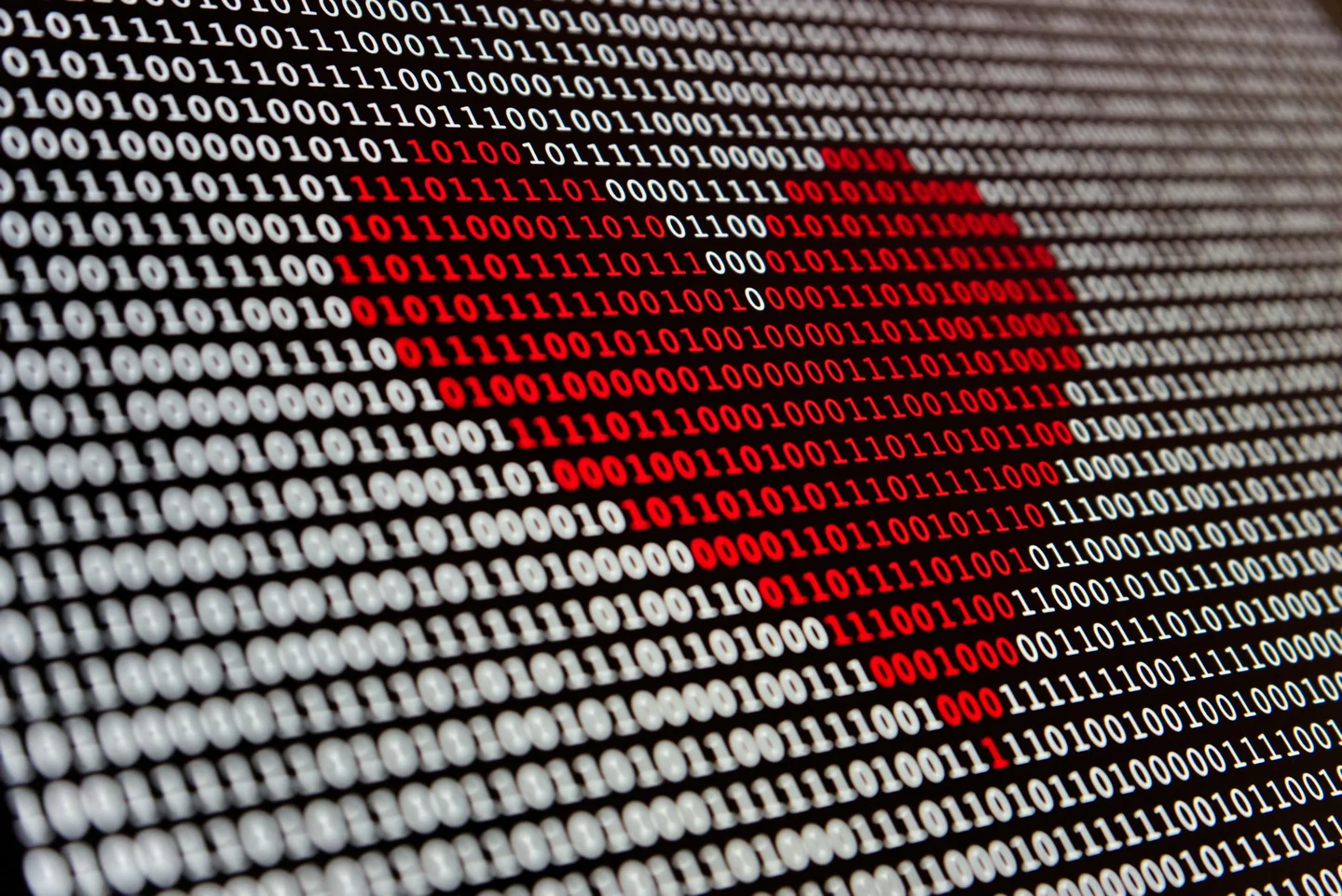 Red heart displayed in a field of binary data
