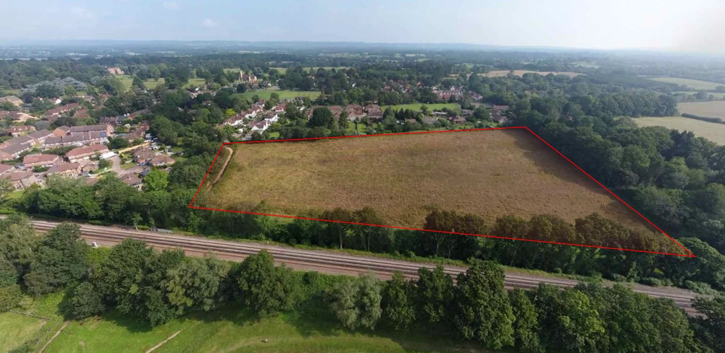 Aerial view of a greenfield site outlined in red