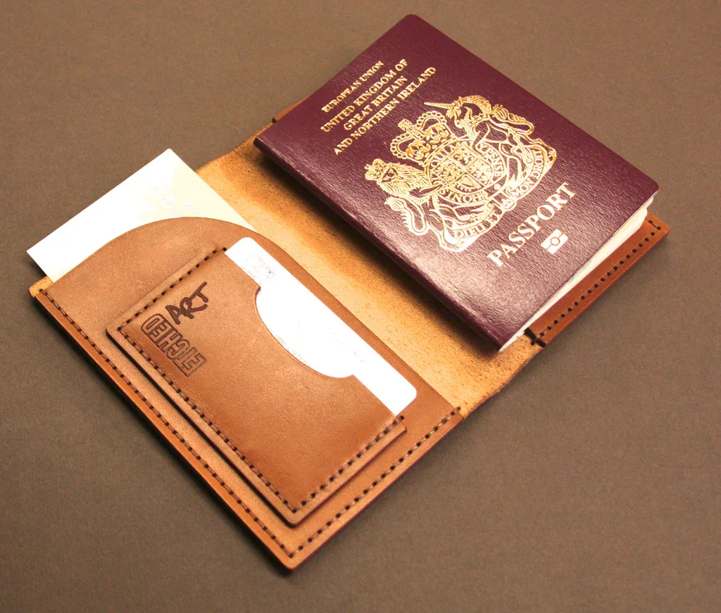 UK passport beside a leather passport holder