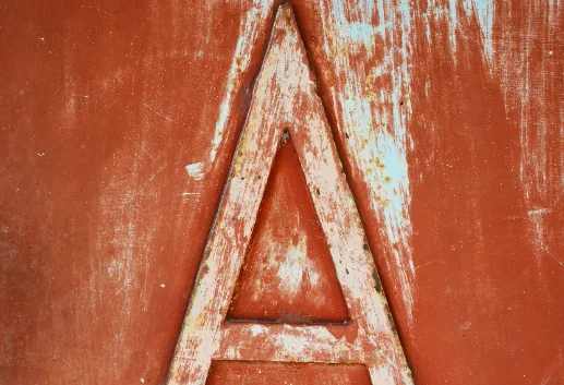 Close-up of a weathered metal letter A