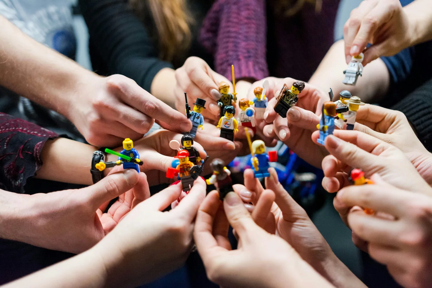 Group of hands holding diverse community figures